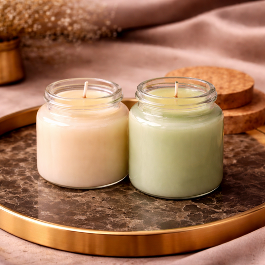 Two pastel scented jar candles on a gold tray — choosing a home fragrance
